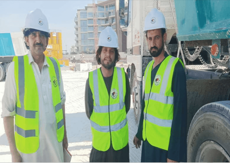 Paktia Star Transport LLC crew in hard hats and safety vests on a Dubai construction site